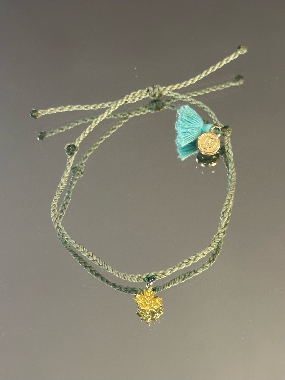 Pura Vida. Olive Green Braided Bracelet with Teal Tassel and Gold Leaf Charm